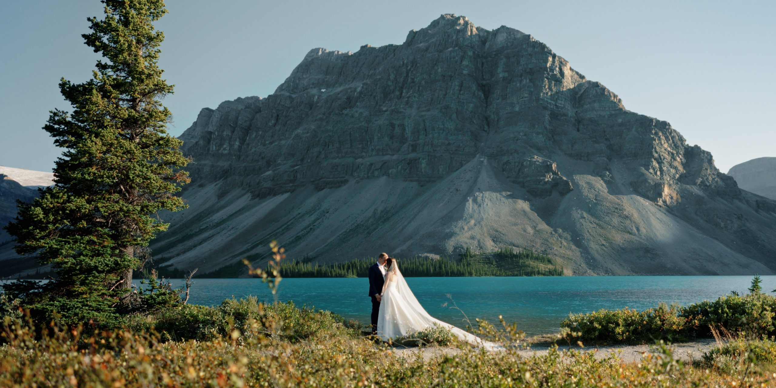 A Banff wedding videographer filming and bride and groom in Banff National Park