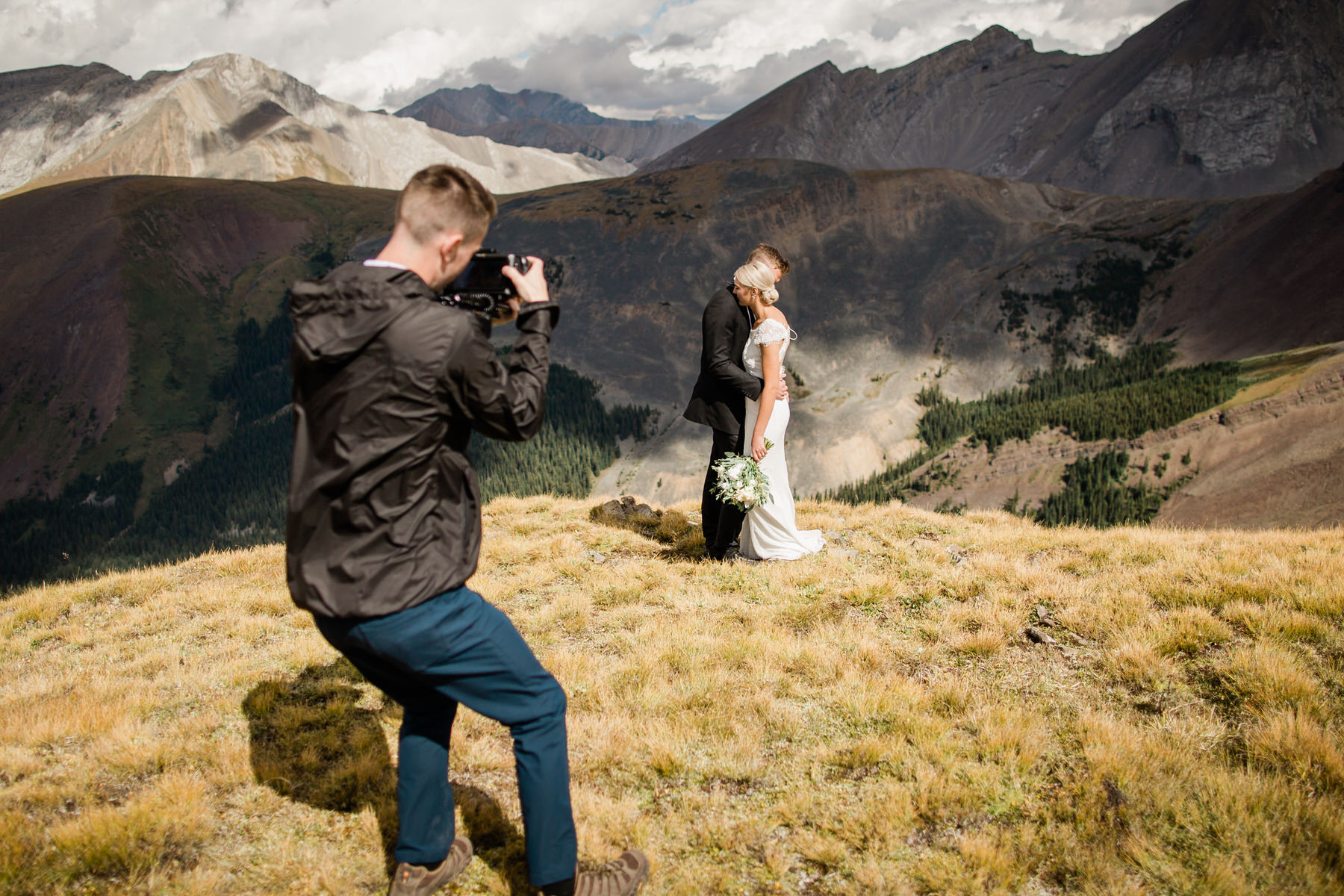 Wedding videographer filming a bride and groom in Banff National Park during a mountain wedding in Alberta.